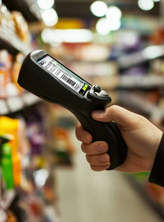 A handheld barcode scanner in a retail aisle